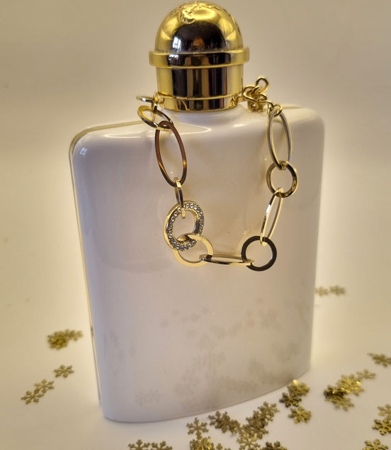 Armband aus goldfarbenen Edelstahlgliedern mit Strass besetztem Mittelring